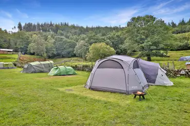Large tents on the electric grass pitches at Torrent Walk Campsite