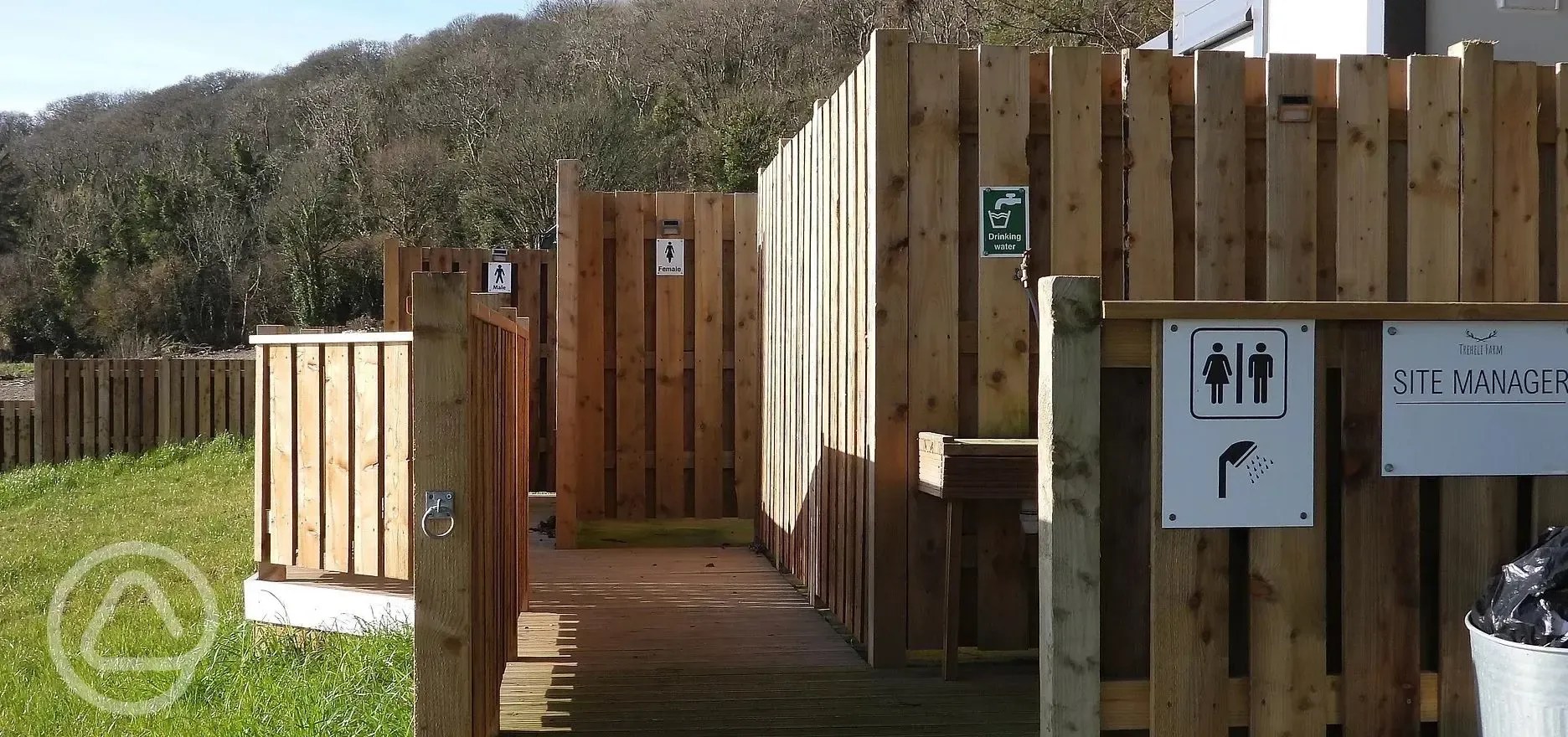 Facilities block exterior with eco toilets, two women's and two men's showers