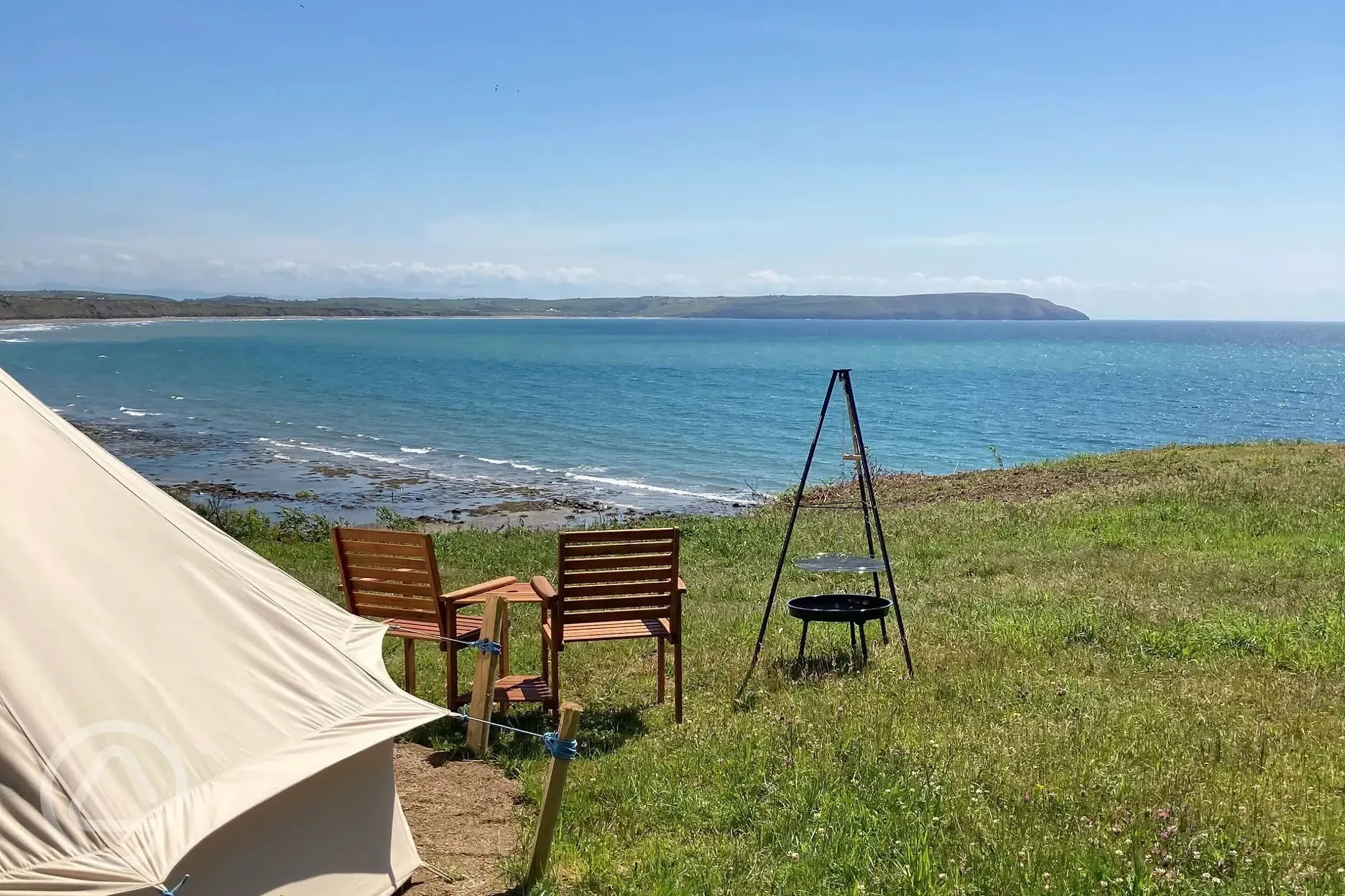 Bell tent with sea view over Cardigan Bay with outdoor seating and firepit