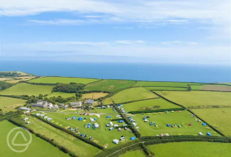 Aerial of the grass pitches at Treveague Campsite overlooking the Cornish coast