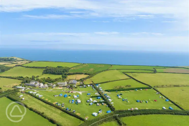 Aerial of the grass pitches at Treveague Campsite overlooking the Cornish coast