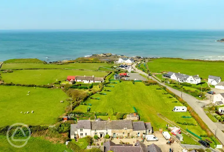 Aerial of Church Bay Cottages Camping and Touring Site towards the coast