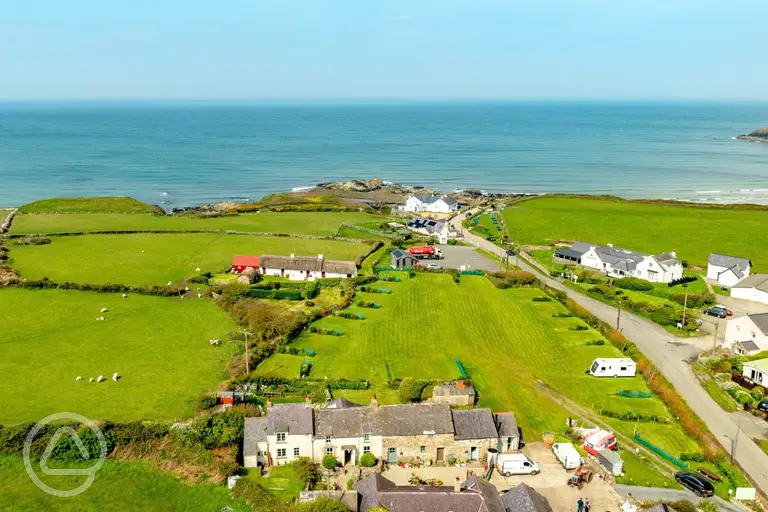Aerial of Church Bay Cottages Camping and Touring Site towards the coast