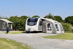 Hardstanding grass touring pitches, rock pegs are recommended for awnings
