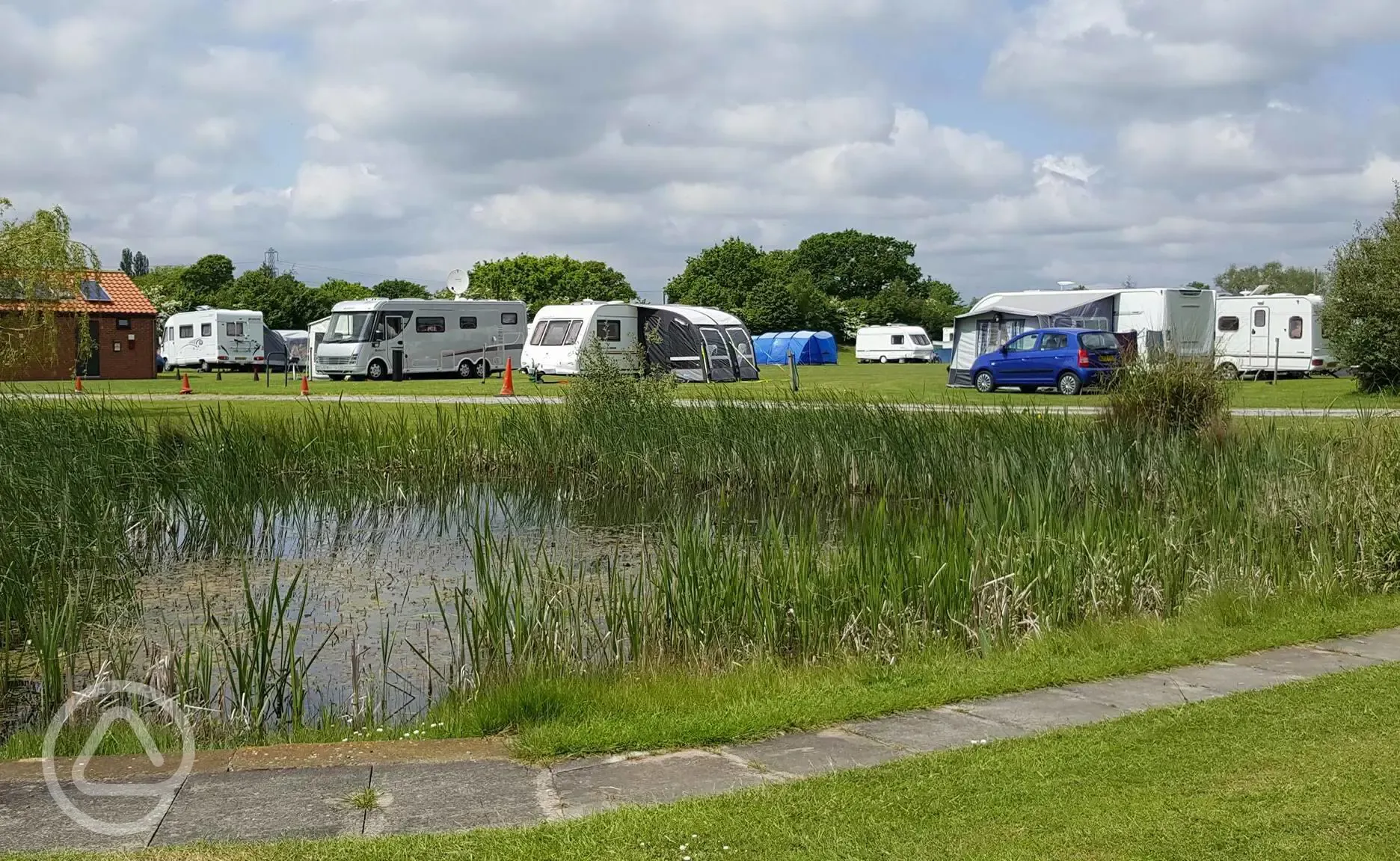 Hardstanding and grass touring pitches by the lake