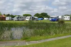 Hardstanding grass touring pitches by the lake