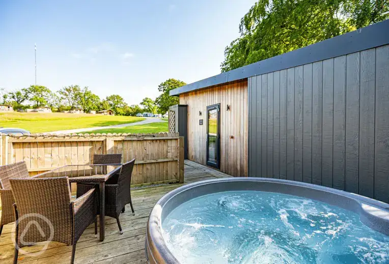 Curlew lodge with a private decking area and electric hot tub