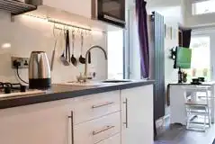 Curlew lodge kitchen with a fridge, kettle, hob, microwave and toaster Curlew lodge kitchen with a fridge, kettle, hob, microwave and toaster