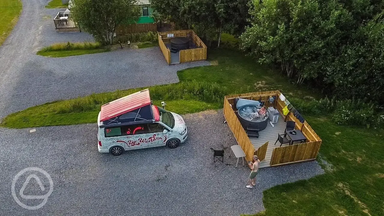 Aerial view of fully serviced pitches with hot tubs and gated decking areas