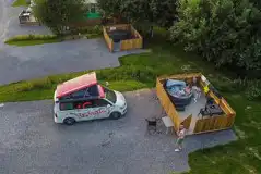Aerial view of fully serviced pitches with hot tubs and gated decking areas