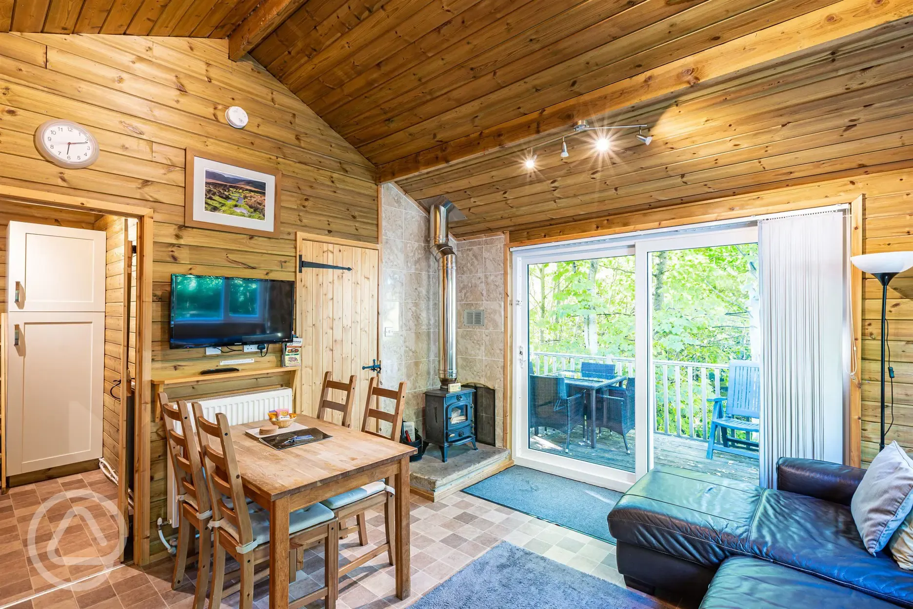 Treehouse Cabin interior with a dining area, sofa and smart TV