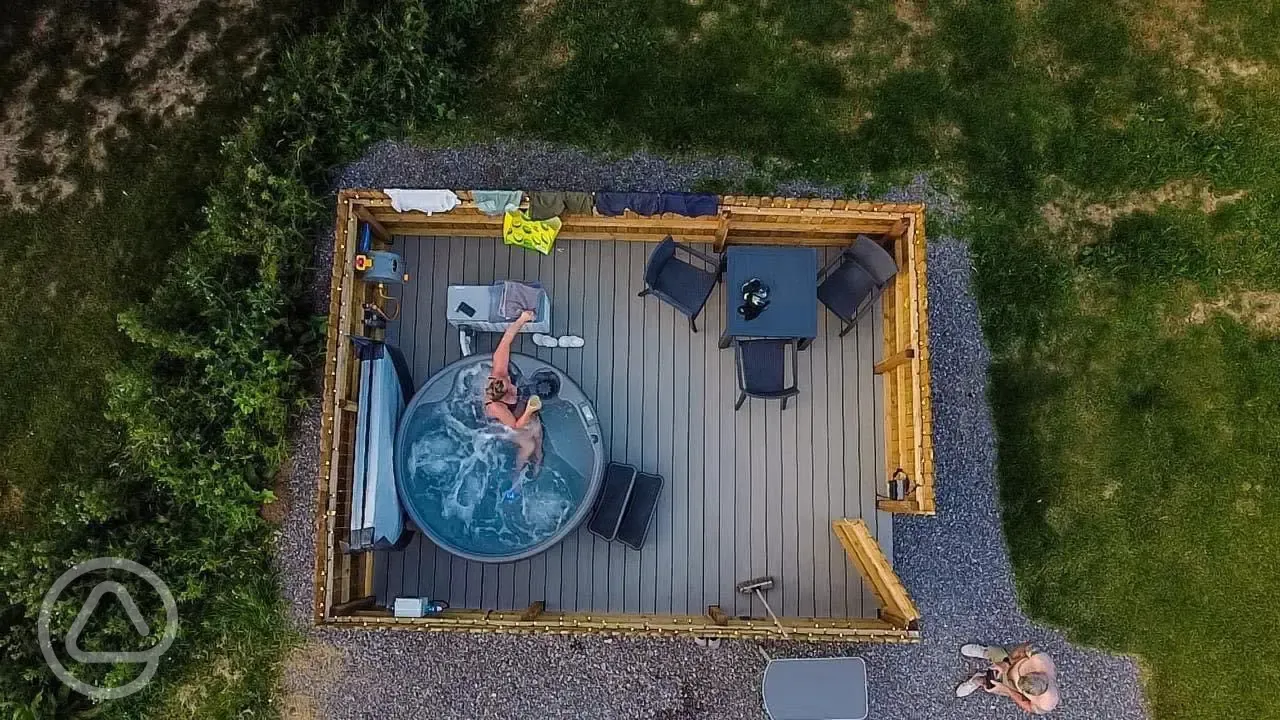 Aerial view of fully serviced pitches with hot tubs and gated decking areas