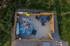 Aerial view of fully serviced pitches with hot tubs and gated decking areas