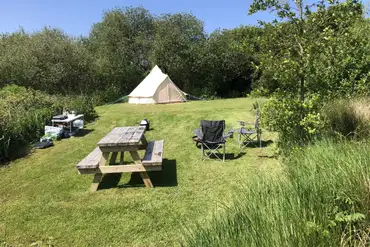 Non electric grass end pitch surrounded by trees