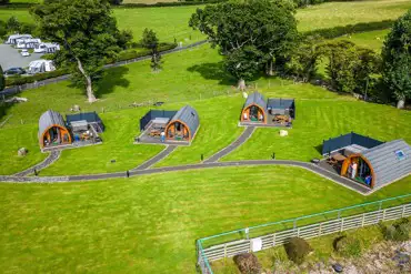 Aerial of glamping pods with hot tubs