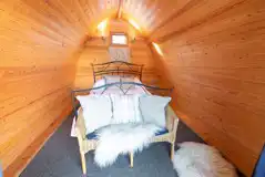 Cosy wooden camping pod interior