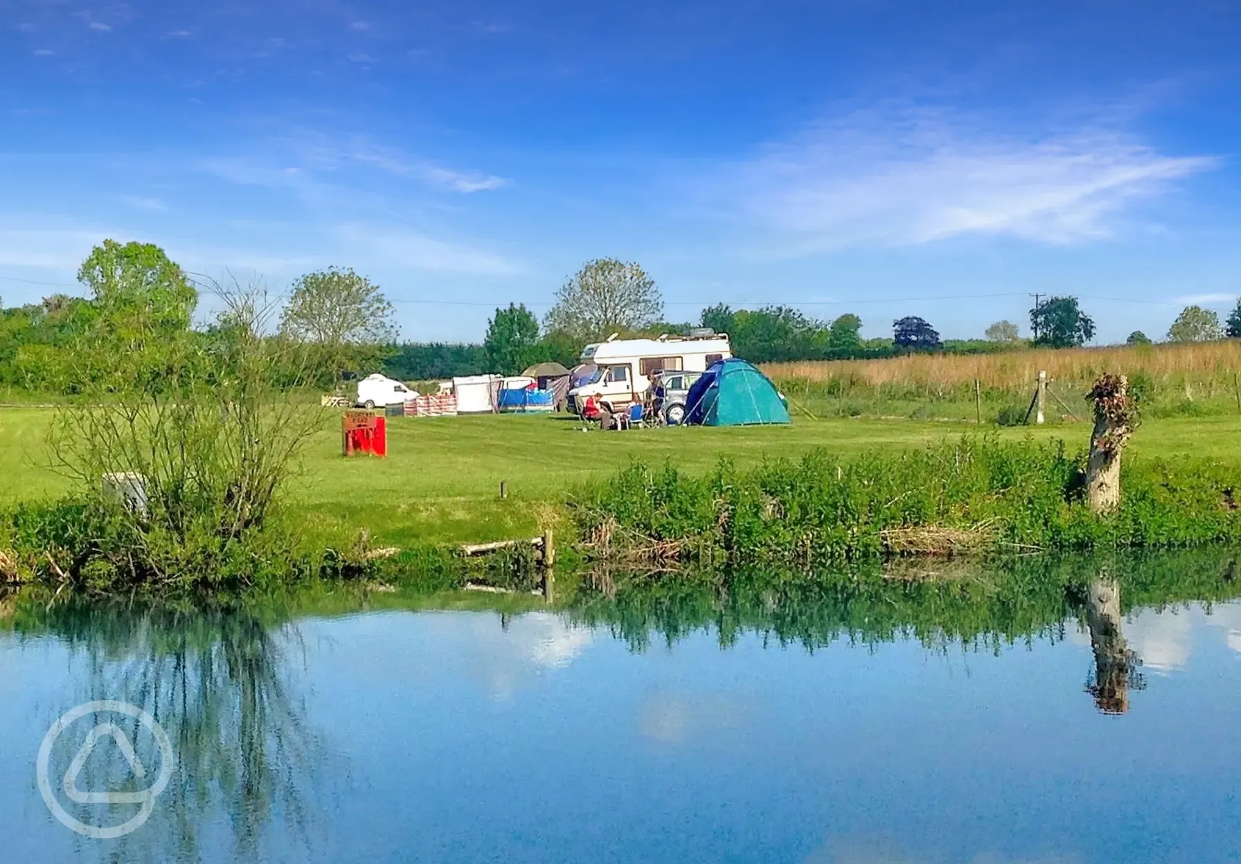 Grass pitches by the lake for tents and tourers Grass pitches by the lake for tents and tourers