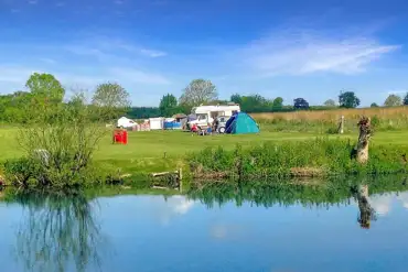 Grass pitches by the lake for tents and tourers