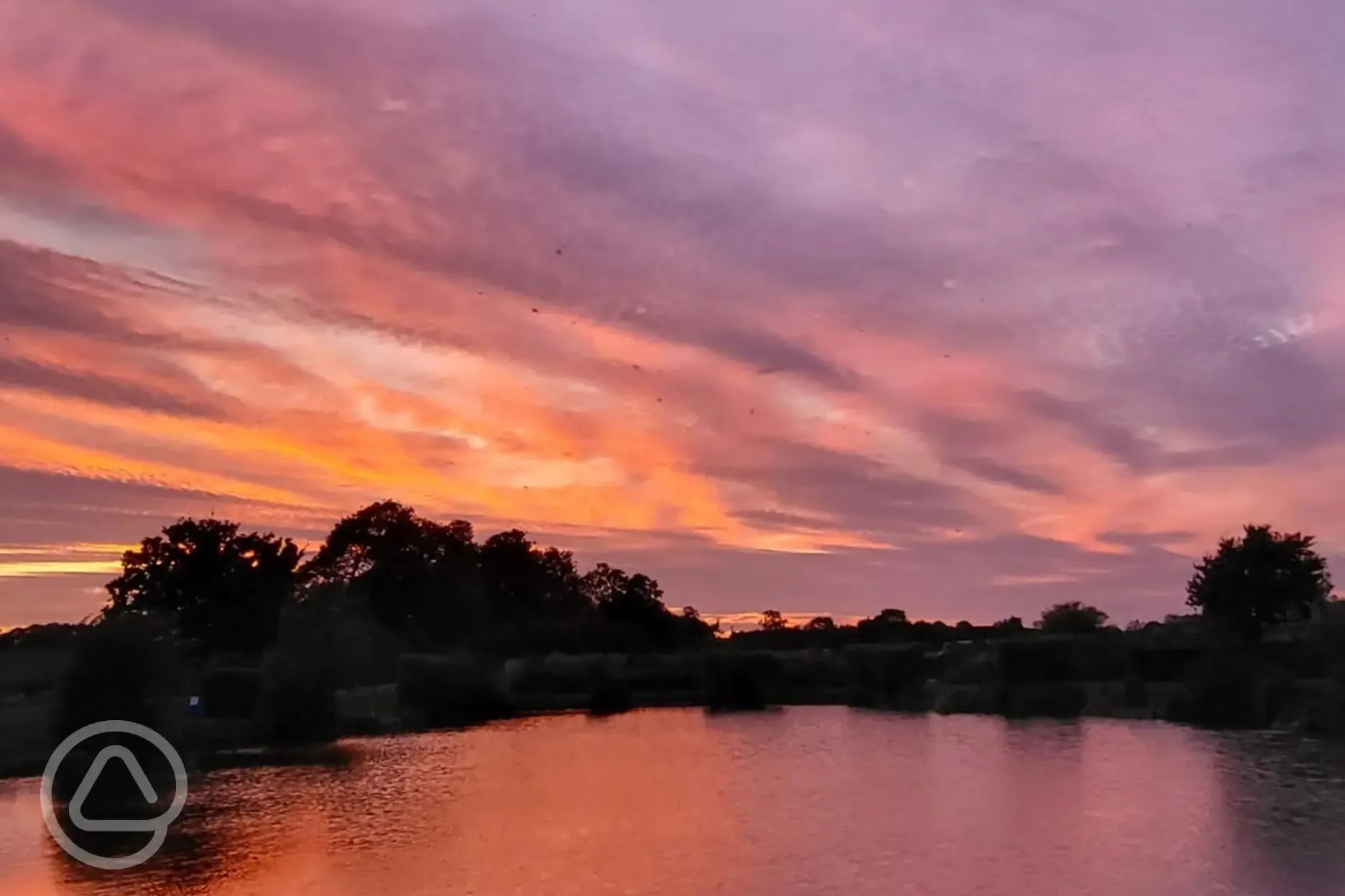 Grass pitches at Field Farm Fisheries during sunset Grass pitches at Field Farm Fisheries during sunset