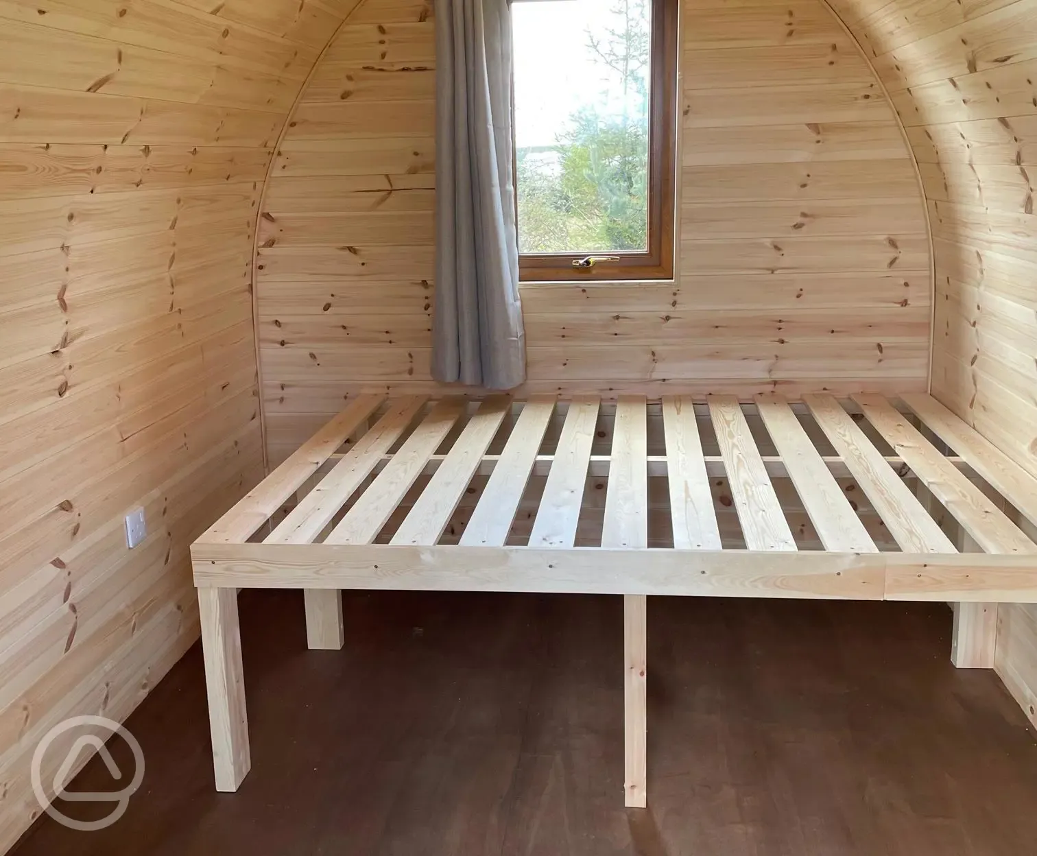 Camping pod interior with a double bed frame Camping pod interior with a double bed frame