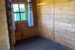 Unfurnished log cabin interior, able to sleep four with solar lighting