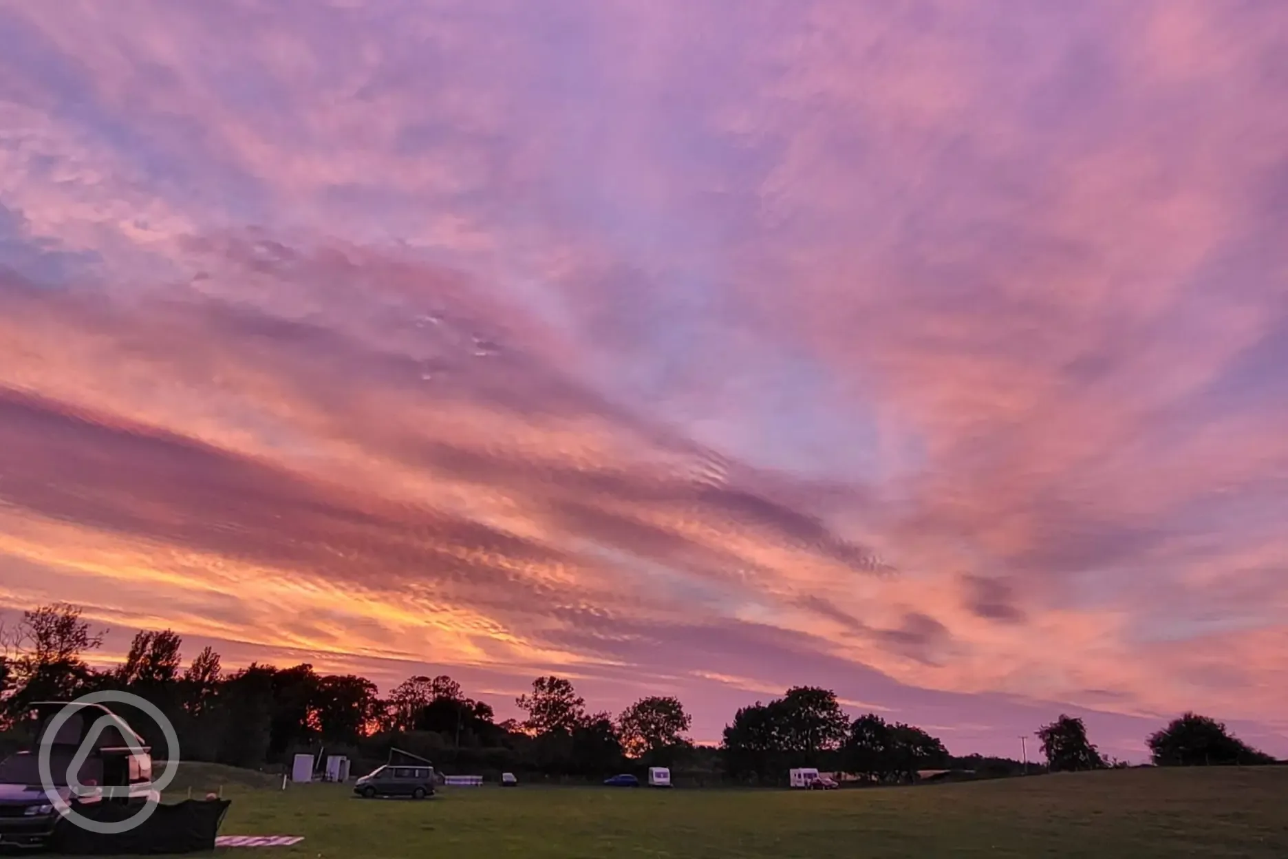 Grass pitches at Field Farm Fisheries during sunset Grass pitches at Field Farm Fisheries during sunset
