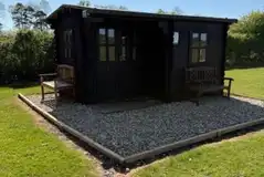 Unfurnished log cabin with outdoor furniture