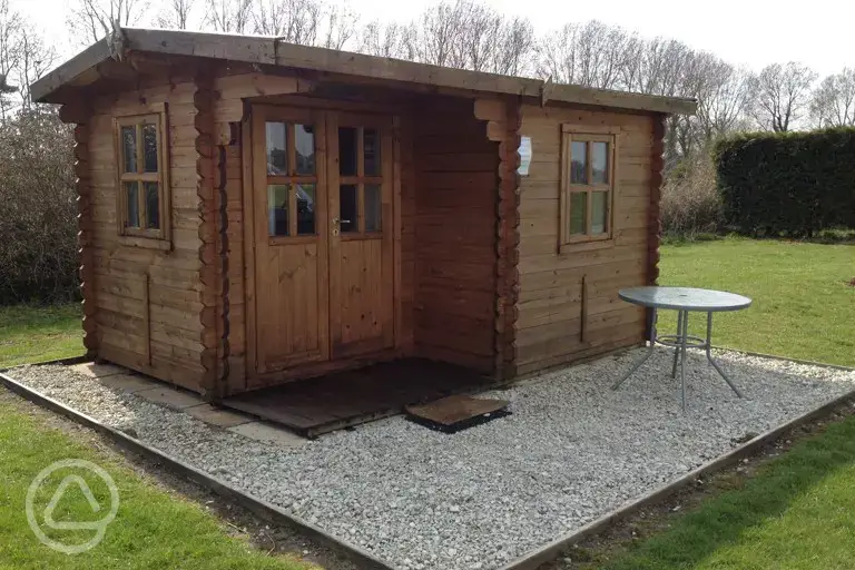 Unfurnished log cabin with outdoor furniture