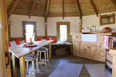 Treehouse living area and kitchen with a log burner, hobs and Belfast sink