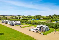 Aerial of the fully serviced hardstanding pitches with awning space Aerial of the fully serviced hardstanding pitches with awning space