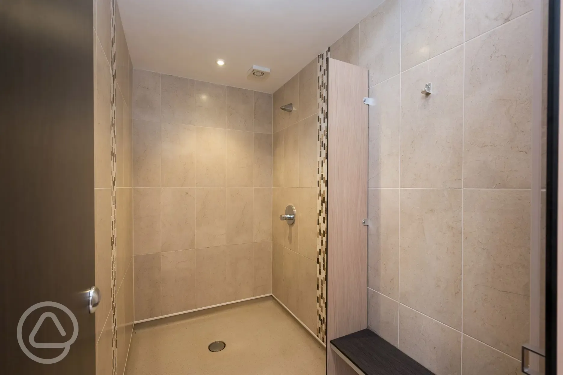 Spacious showers with unlimited hot water, benches, and hooks