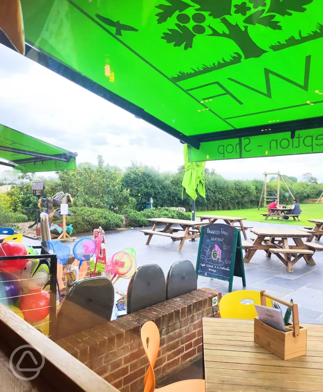 Haw Wood Farm's café and shop with outdoor seating by the play area