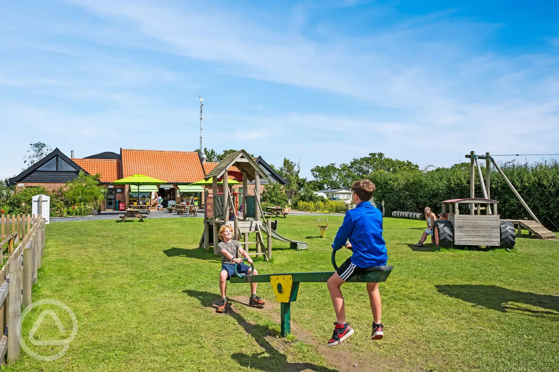 Haw Wood Farm's play area with climbing frames, zip wire, see-saw, and slides