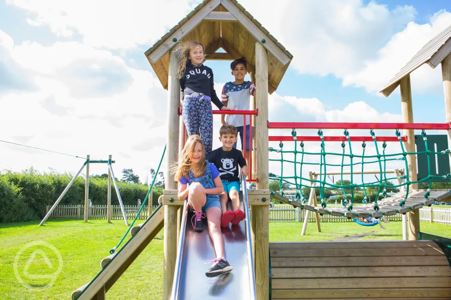 Kids playing on the slides in the playground Kids playing on the slides in the playground