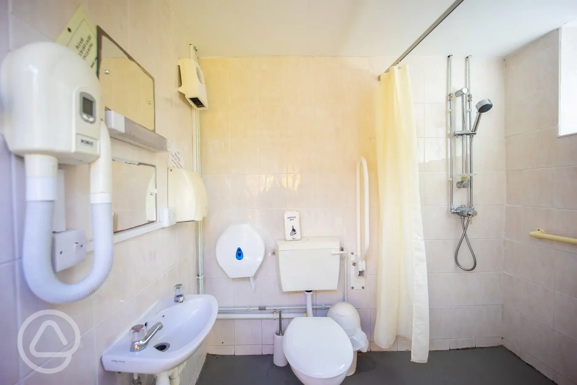 Disabled bathroom with grab rails and a shower