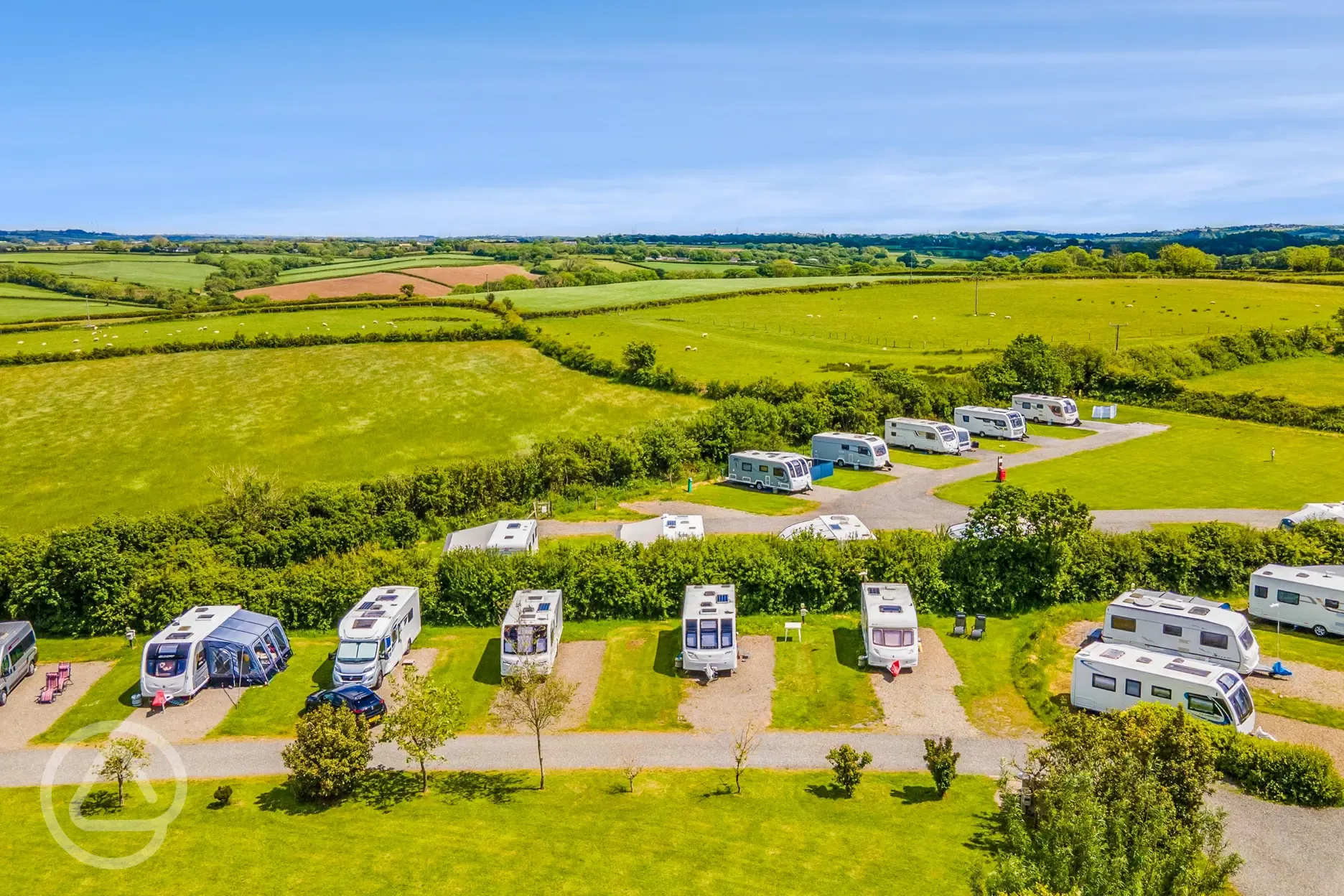 Aerial view of electric hardstanding touring pitches with rural views