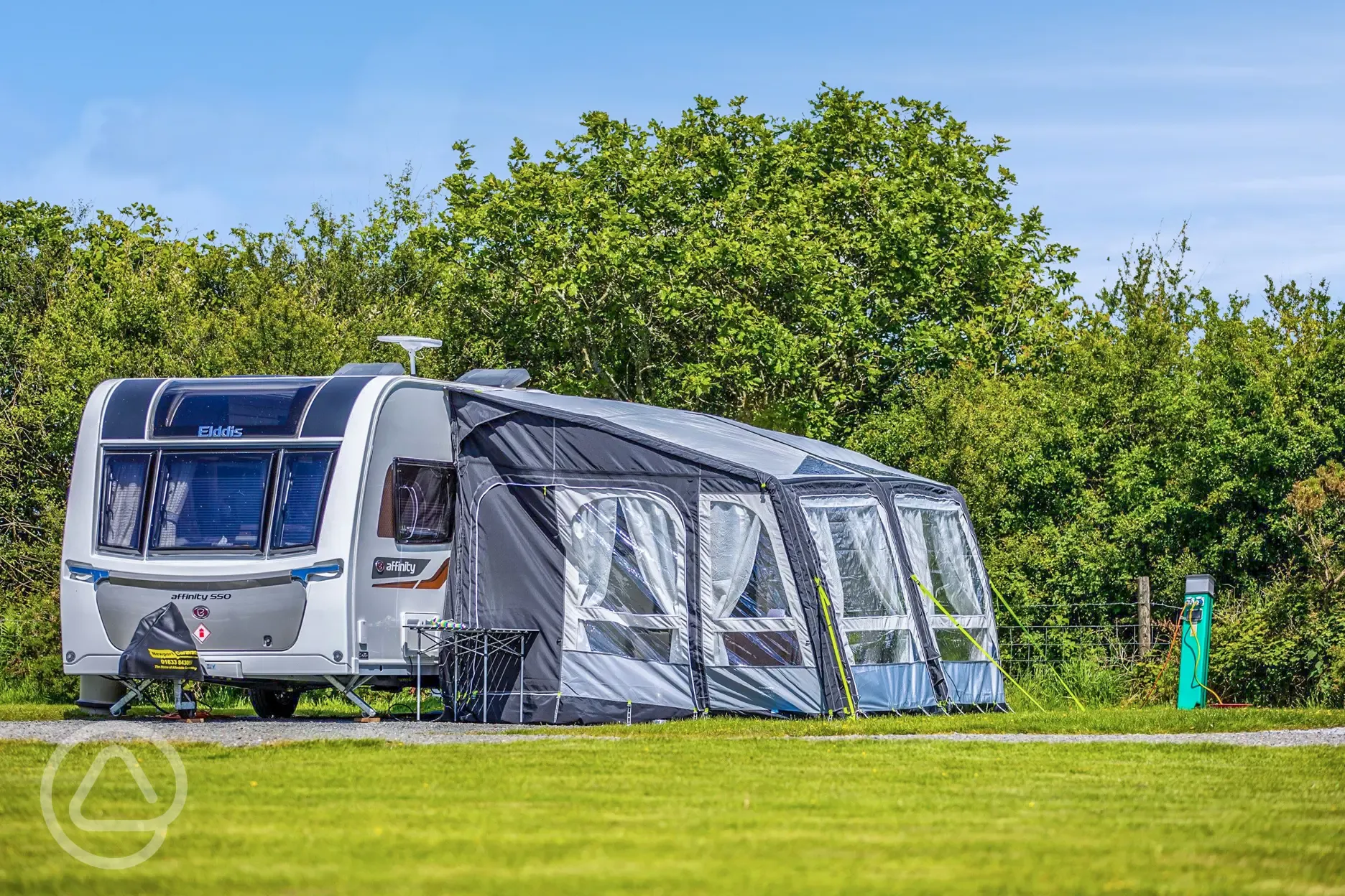 Caravan with awning on a fully serviced hardstanding pitch at Hungerford Farm