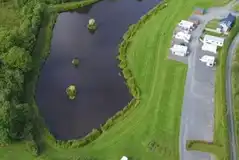 Aerial of the lake and pitches at Spring Rock Holidays 