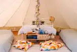 Furnished bell tents with a double bed and two fold out beds