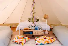 Furnished bell tents with a double bed and two fold out beds