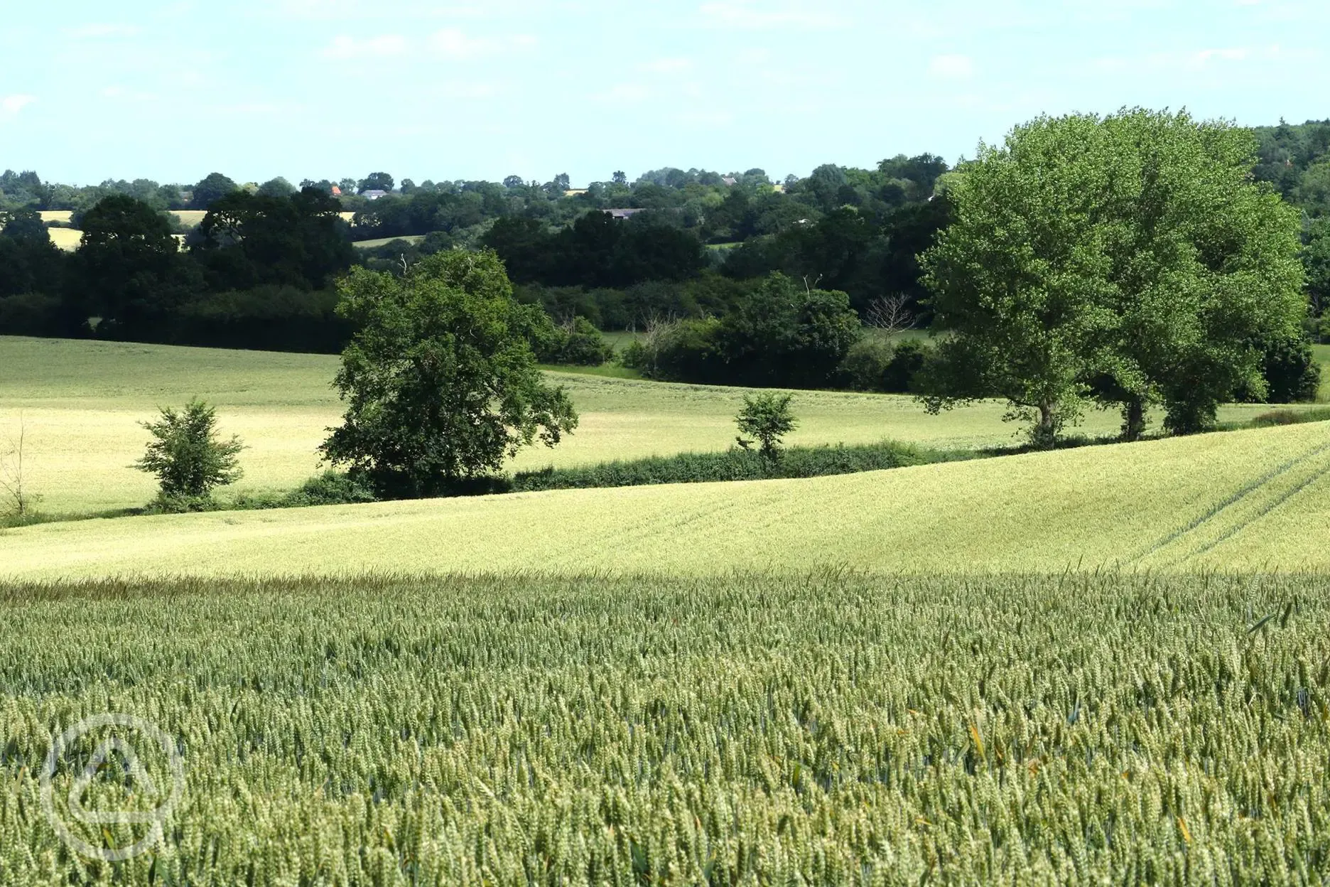 the site is surrounded by fields and woodlands