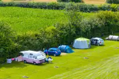 Aerial of the non electric grass pitch with sunken fire pits