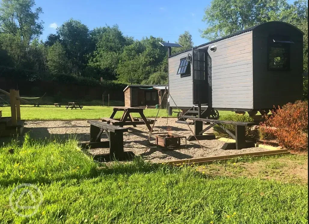 Shepherd's hut outside the large bell tent