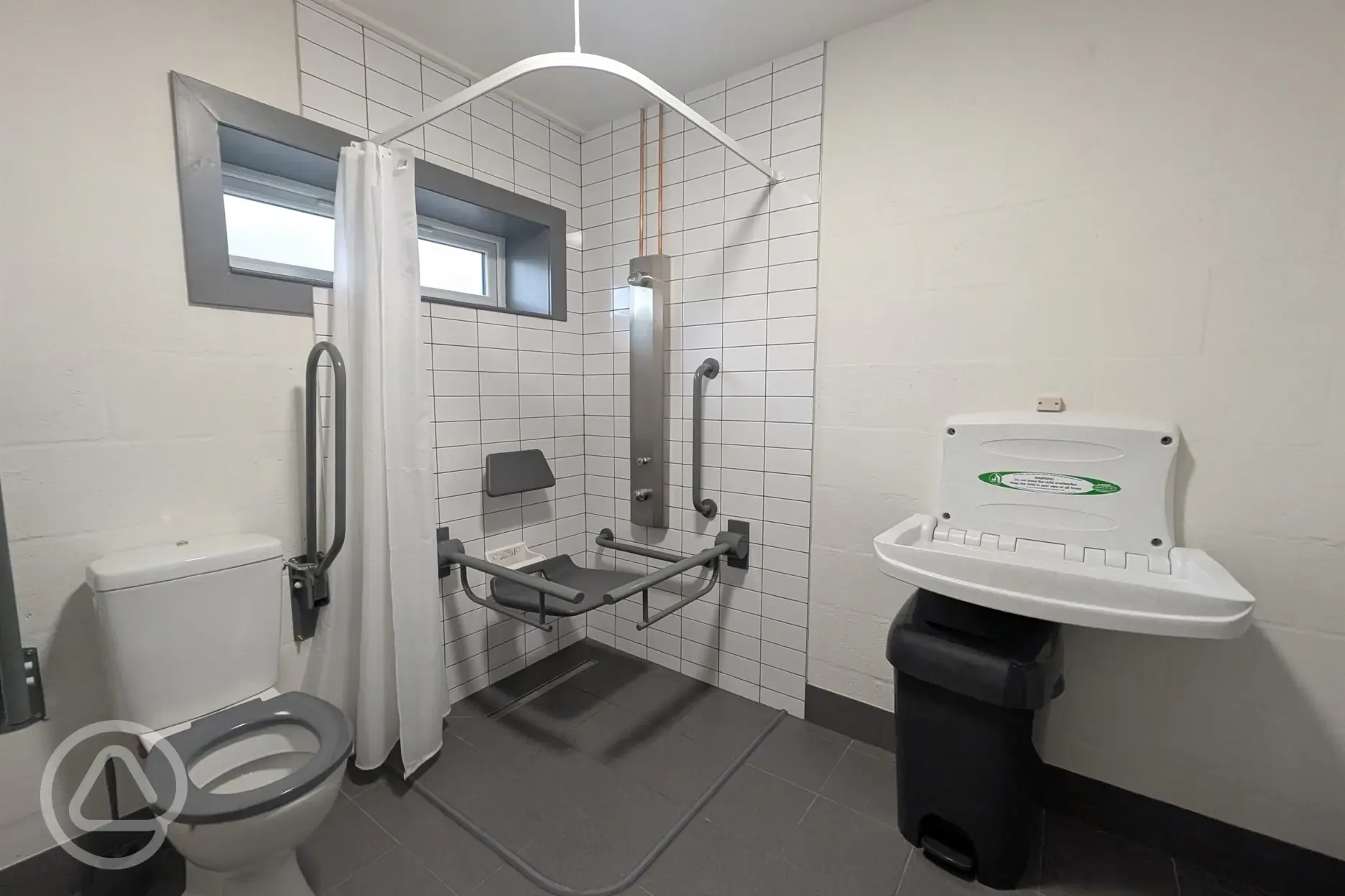 Accessible facilities with a grab rail and baby changing facilities