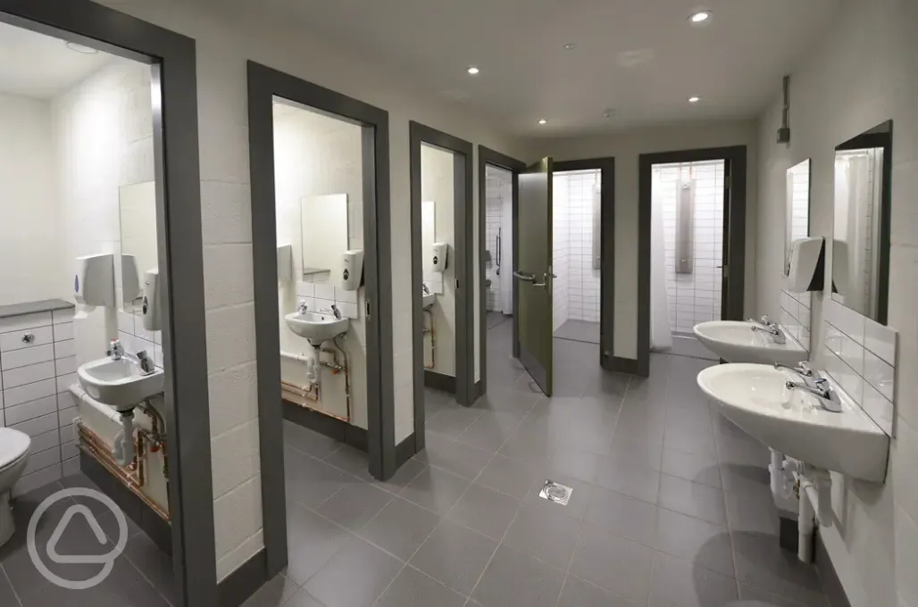 Toilets and shower cubicles with hot running water
