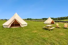 Unfurnished bell tents with outdoor seating Unfurnished bell tents with outdoor seating