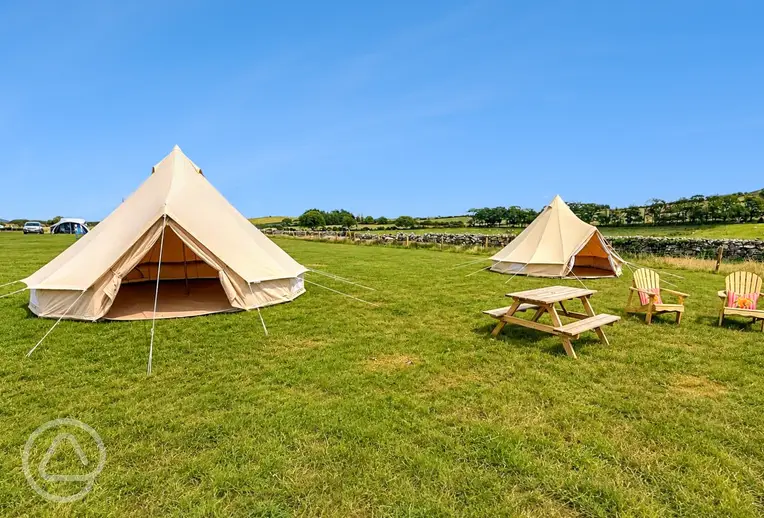Unfurnished bell tents with outdoor seating