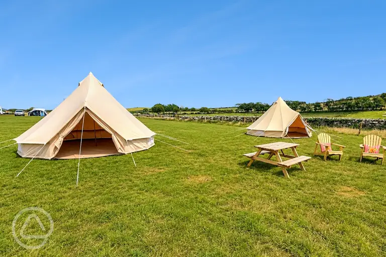 Unfurnished bell tents with outdoor seating