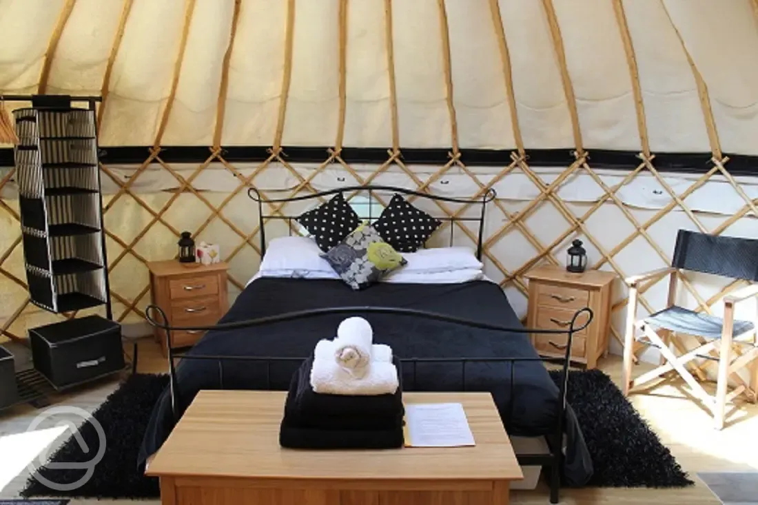 Inside one of our luxury yurts.  Proper king sized bed, two single futons and contemporary oak furniture.