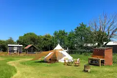 Shepherd's hut and bell tent at Rectory Farm Caravan Camping and Fishing Site